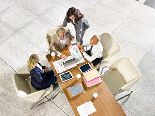 multiethnic team of corporate executives meeting in office