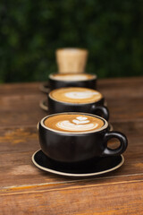 some coffee latte cups aligned in a table 
