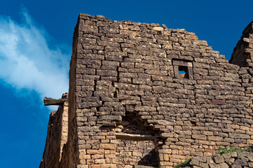 ruins of stone walls against the sky in the ancient abandoned village of Gamsutl