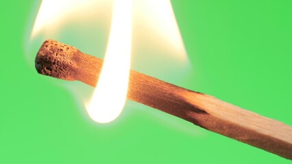 Close up of a standard lit match with a green screen background. Looks like it is dying out, but...