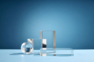 Front view of transparent podium glassware decorated in blue background with blank space