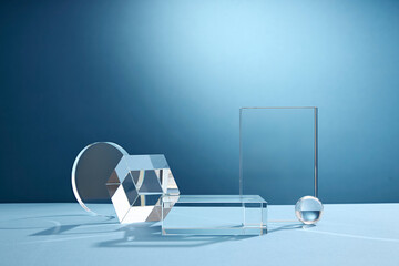 Front view of transparent podium glassware decorated in blue background with blank space