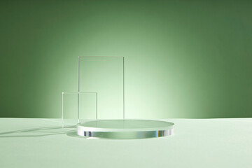 Front view of transparent podium glassware decorated in green background with blank space
