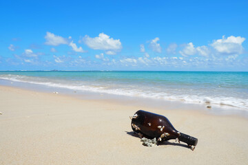 Fototapeta na wymiar old glass bottle on the sandy beach