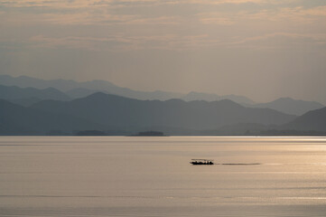 view of sunset over lake in Thailand