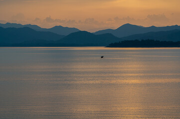 view of sunset over lake in Thailand
