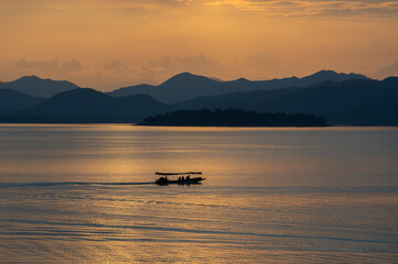 view of sunset over lake in Thailand