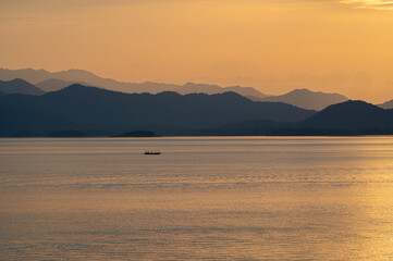 view of sunset over lake in Thailand