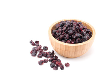 Dried cranberries in woodle bowl isolated on white background.