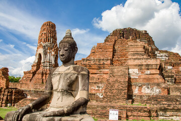 The Buddha statue  in Wat Mahathat (Temple of the Great Relic),  a Buddhist temple in Ayutthaya Thailand. 
The history of this temple starts in 1374.  - obrazy, fototapety, plakaty