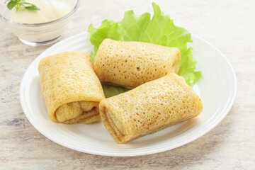 Stuffed pancakes with meat and cream