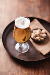 Glass of beer on wooden background. Copy space.