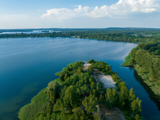 Fototapeta na wymiar Aerial view of green lake nad forest in Poland. Summer time. 