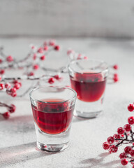 Homemade infused vodka, tincture or liqueur of red cherry on white background. Berry alcoholic...