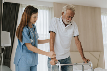 Asian nurse helping senior man to walk around in house. young nurse helping senior man at home. Senior health care.