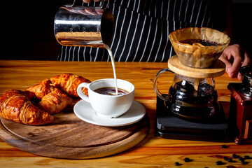 How to make coffee latte by barista in vintage color tone coffeeshop, drip coffee concept.