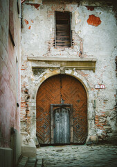 entrance gate on abandoned building with weathered facade