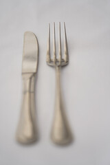 knife and fork placed on a table in the restaurant. detail.