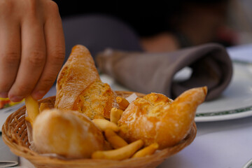 basket with bread and sticks on a restaurant table. photo inside.