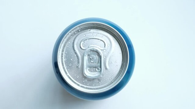 hand takes a metal can of a cool drink