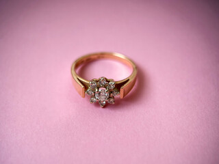 Gold diamond ring on pink isolated background. Red Gold Ring