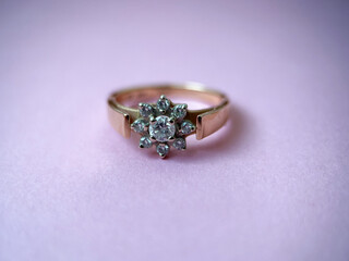 Gold diamond ring on pink isolated background. Red Gold Ring