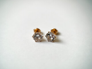 Gold stud earrings with cubic zirconia close-up