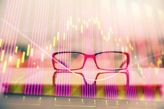 Financial graph hologram with glasses on the table background. Concept of business. Double exposure.