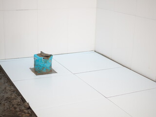 Laying tiles at home. closeup photo, blurred.