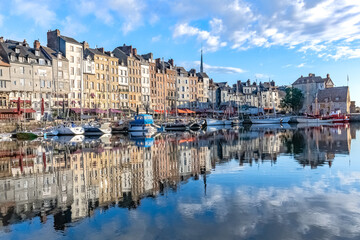 Fototapeta na wymiar Honfleur, beautiful city in France, the harbor in the morning, reflection on the river 