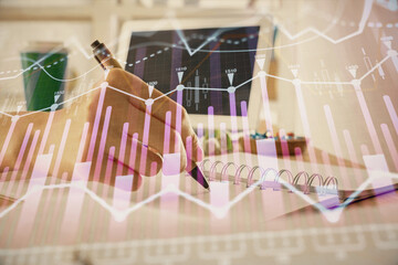 Financial forex graph drawn over hands taking notes background. Concept of research. Multi exposure