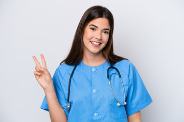 Young Brazilian nurse woman isolated on white background smiling and showing victory sign