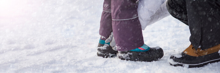 Winter shoes in the snow. Close-up of winter shoes. Children's waterproof shoes for walking in the...