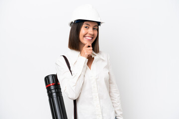 Young architect woman with helmet and holding blueprints isolated on white background happy and smiling