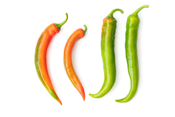 A group of delicious red and green hot and tasty peppers with shiny skins isolated with clipping path on a white background. Spicy ingredients and flavoring