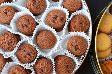An overhead or flat lay view of Danish butter cookies in the traditional tin box. It's a Denmark delicacy consisting of butter, flour, and sugar. Danish chocolate chip biscuits. Copy space.