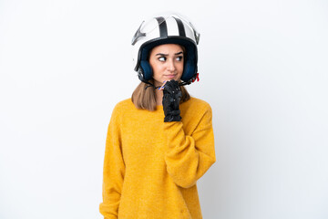 Young caucasian woman with a motorcycle helmet isolated on white background and looking up