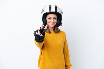 Young caucasian woman with a motorcycle helmet isolated on white background smiling and showing victory sign
