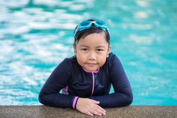 happy children Smiling cute little girl in sunglasses in swimming pool