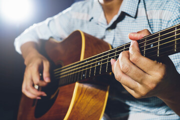 Closeup of hand playing  acoustic guitar