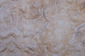 Beige stone wall background. Interior or exterior stone wall.