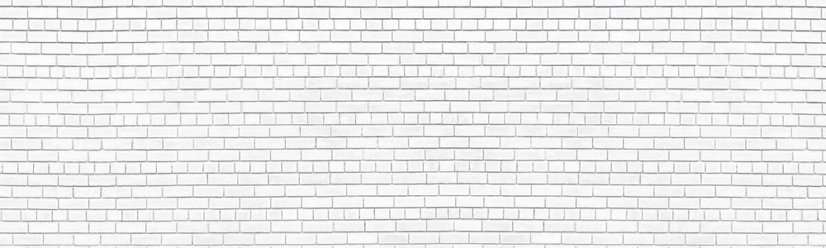 Whitewashed old brick wall wide texture. Shabby white painted exterior masonry. Abstract light grey vintage large background