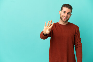 Handsome blonde man over isolated blue background happy and counting four with fingers