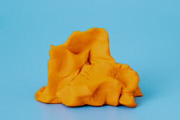 Play dough clay or colorful plasticine on blue background in studio. Preschool activities and creativity education