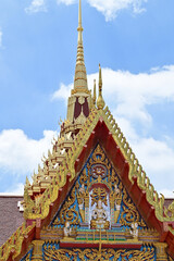 Fototapeta premium Part of the Roof of a temple in Thailand. Traditional Thai style pattern on the roof of a temple with Blue Sky Background.