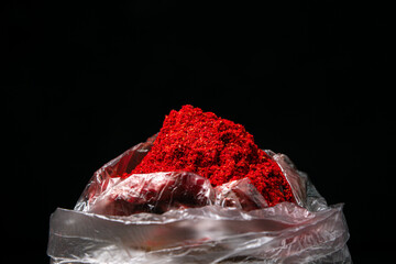 Ground red pepper on a black background. Hot red pepper. ground paprika
