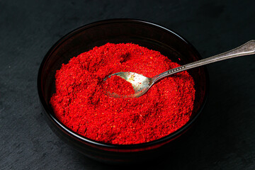 Ground red pepper on a black background. Hot red pepper. ground paprika