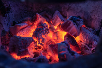 Close-up photo of hot coals in a clay oven