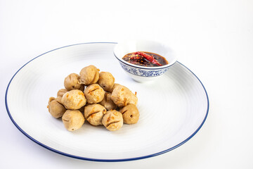 Grilled pork balls with sweet chili sauce in white plate on white background. Snack foods.