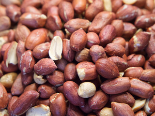 Roasted unpeeled peanuts macro, peanuts as a background. Groundnut Texture